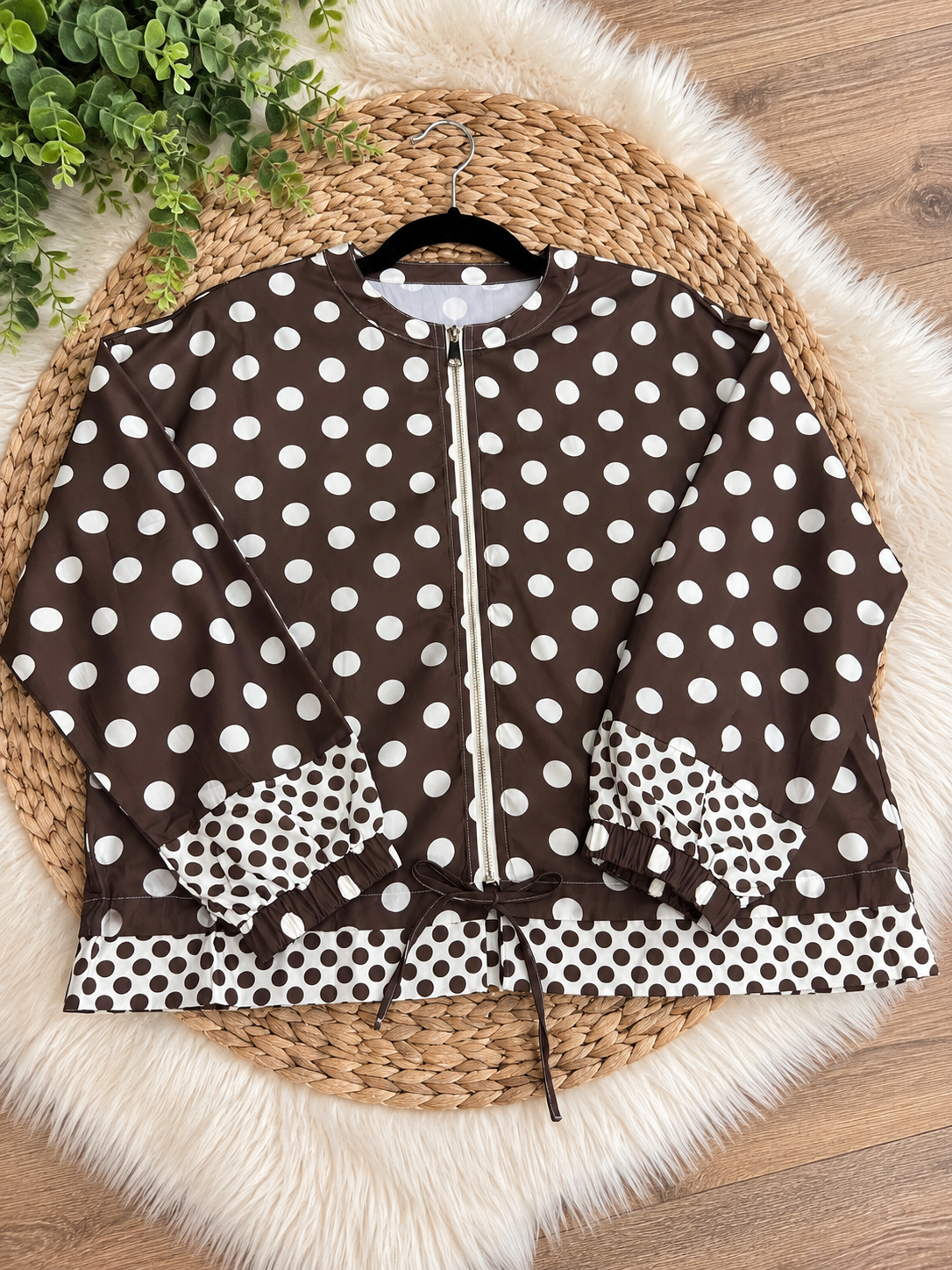 Chocolate brown and white polka dot jacket flat lay